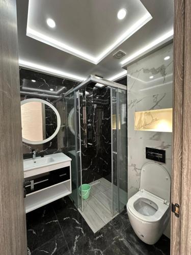 a bathroom with a shower and a toilet and a sink at اقامة الانوار in Nador