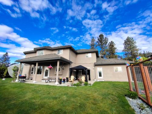 a house with a fence in a yard at 1 BDRM 1 BTH Suite with Private Entry in West Kelowna