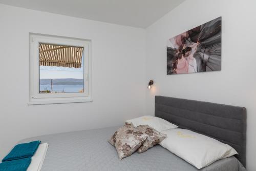 a bedroom with a bed and a window at Apartments with parking space Stanici, Omis - 11421 in Celina