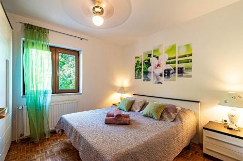a bedroom with a bed with a purse on it at Apartments by the sea Tri Zala, Korcula - 4432 in Korčula