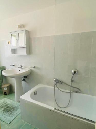 a bathroom with a bath tub and a sink at A Casa Lucia in Montefiascone