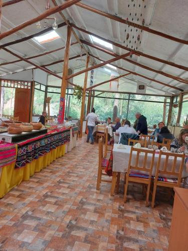 a restaurant with people sitting at tables in a tent at Casa Turística Las Tunas in Huancarani