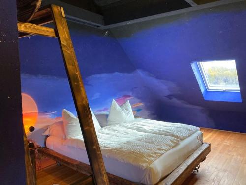 a bedroom with a bed with a blue wall at Zum süßen Stollen in Reinsfeld