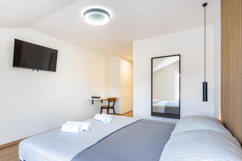 Ένα ή περισσότερα κρεβάτια σε δωμάτιο στο Apartments & Rooms Klemenc