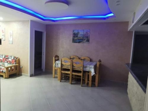 a dining room with blue lights on the ceiling at قرية جامعة القاهرة الكيلو 44 الساحل الشمالى 10 in Dawwār Abū Maḩrūs