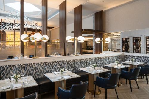 a restaurant with tables and chairs and a bar at The Ritz-Carlton, Chicago in Chicago