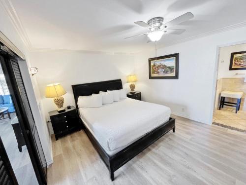 a bedroom with a bed and a ceiling fan at Catalina Courtyard Suites in Avalon