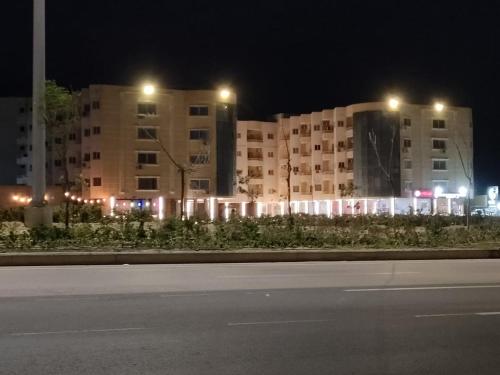 a large building with lights in front of it at night at Dalina الساحل الشمالي قدام مراسي in El Alamein