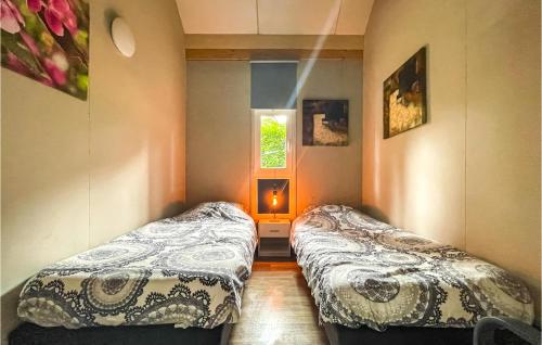 Duas camas num pequeno quarto com uma janela em Awesome Home In Meijel With Sauna em Meijel