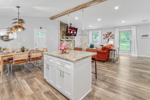 a kitchen and living room with a dining room at Vibrant South CLT Oasis, 3BRs, Patio, Fire Pit in Charlotte
