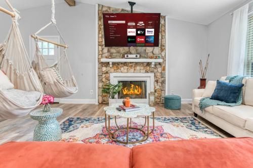 a living room with a couch and a fireplace at Vibrant South CLT Oasis, 3BRs, Patio, Fire Pit in Charlotte