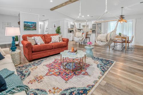 a living room with a red couch and a rug at Vibrant South CLT Oasis, 3BRs, Patio, Fire Pit in Charlotte