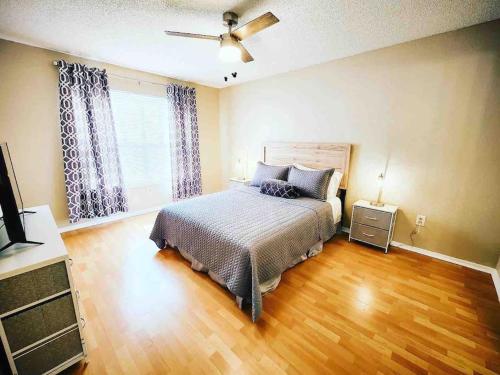 a bedroom with a bed and a ceiling fan at Cozy & spacious 2 BR / 2 BA condo in Kissimmee