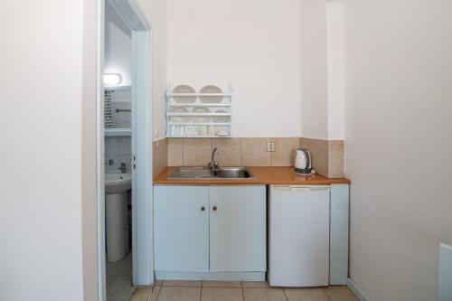 a small kitchen with a sink and a counter at Karpathios Studios Pefkos in Pefki Rhodes