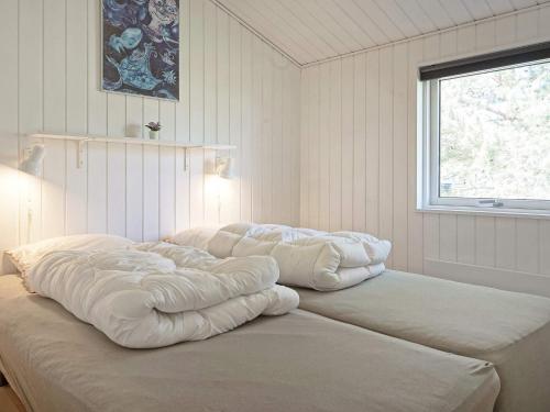 two large pillows sitting on top of a bed in a room at 8 person holiday home in Nexø in Neksø