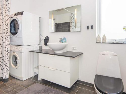 a bathroom with a sink and a washing machine at Holiday home Aabenraa LXXIV in Aabenraa