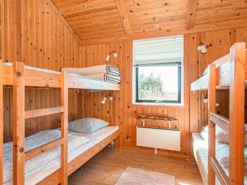 a log cabin with bunk beds in it at 9 person holiday home in Harboøre-By Traum in Harboør