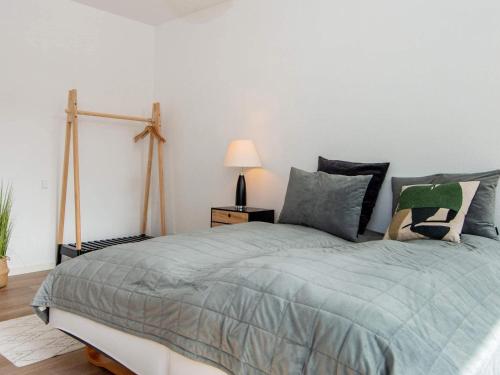 a bedroom with a bed with a green comforter at Apartment in Holiday park- shared kitchen in Ulfborg
