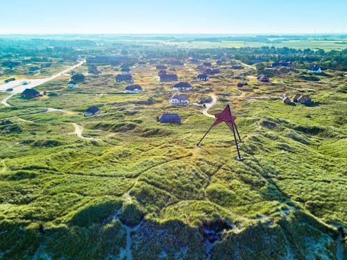 a kite flying over a grassy field with houses at Apartment in Holiday park- shared kitchen in Ulfborg