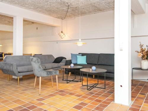 a living room with couches and tables at Apartment in Holiday park- shared kitchen in Ulfborg