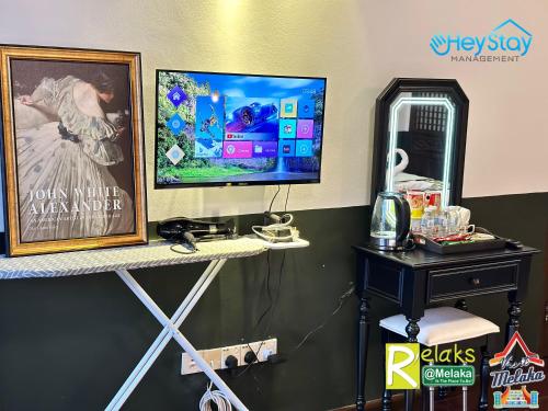 a computer monitor on a shelf in a room at Wayfarer Guest House Jonker Street Melaka By Heystay Management in Melaka