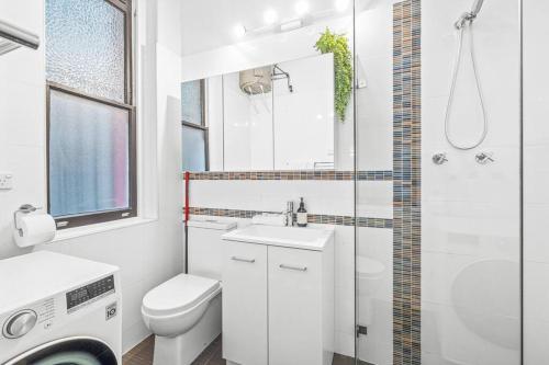 a bathroom with a toilet and a sink and a shower at Kings4 Self Catering in Sydney