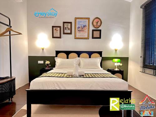 a bedroom with a large bed with white pillows at Wayfarer Guest House Jonker Street Melaka By Heystay Management in Melaka