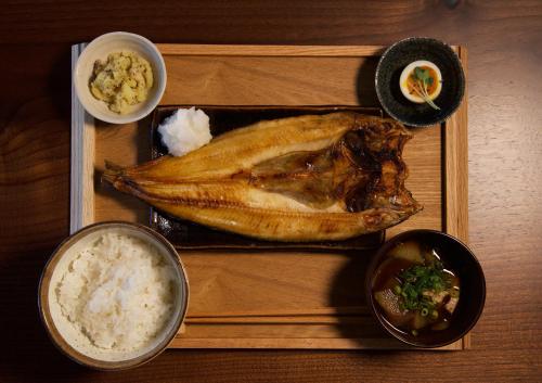 a tray with a chicken and rice and other foods at HOTEL BOTH in Shari