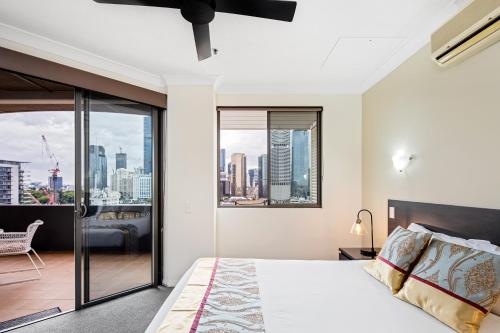 a bedroom with a bed with a view of the city at Bridgewater Apartments in Brisbane
