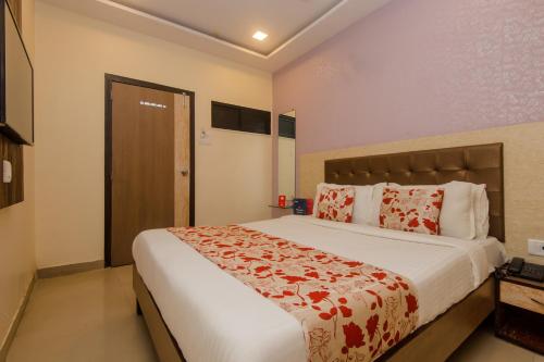 a bedroom with a large bed in a room at Hotel Golden Nest Near Chhatrapati Shivaji International Airport in Mumbai