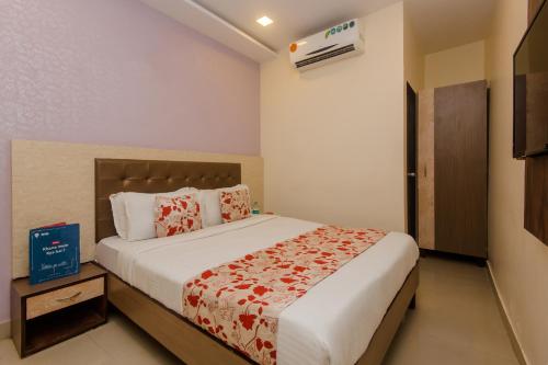 a bedroom with a large bed in a room at Hotel Golden Nest Near Chhatrapati Shivaji International Airport in Mumbai