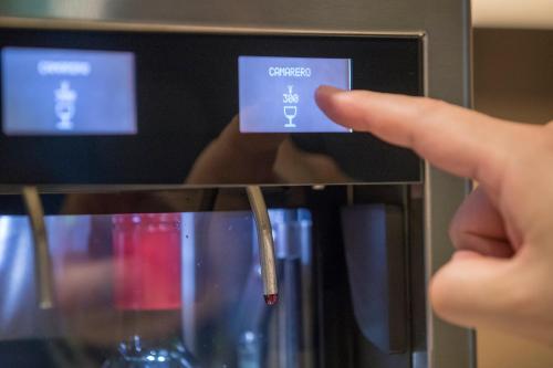 a person pointing at a sign on a wine glass at Hotel Forza Oita in Oita