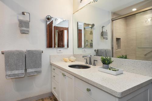 a bathroom with a sink and a mirror at Waikomo Streams 203 in Koloa