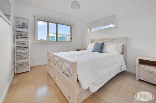 a bedroom with a large bed and a window at Bridgey Escape in Cape Bridgewater