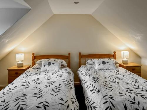 A bed or beds in a room at Eleven Diabaig Cottage