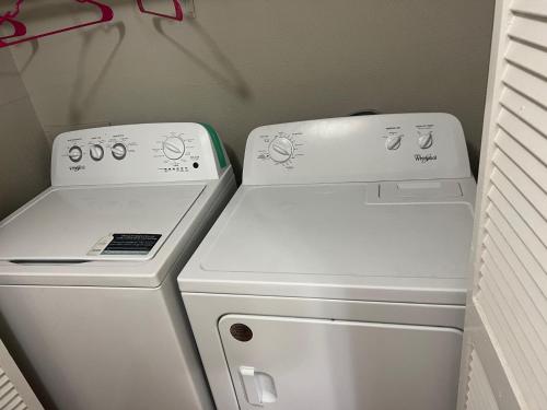 a white stove and a washer and dryer in a room at Lovely 1-Bedroom Townhome with Nice Amenities in Houston