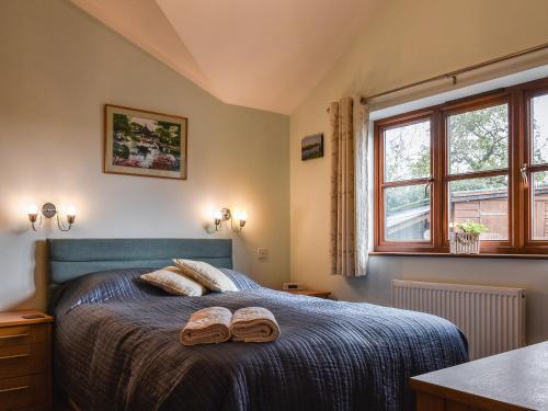 a bedroom with a bed with two slippers on it at Harvest View in Coton