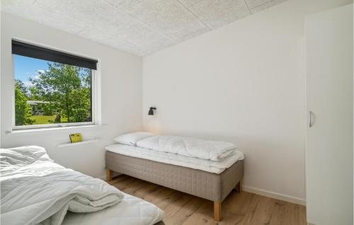 Amazing Home In Ebeltoft With Kitchen في إيبلتوفت: غرفة نوم بسرير ونافذة