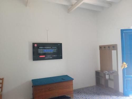 a room with a tv on the wall at Casa Galletta in Stromboli