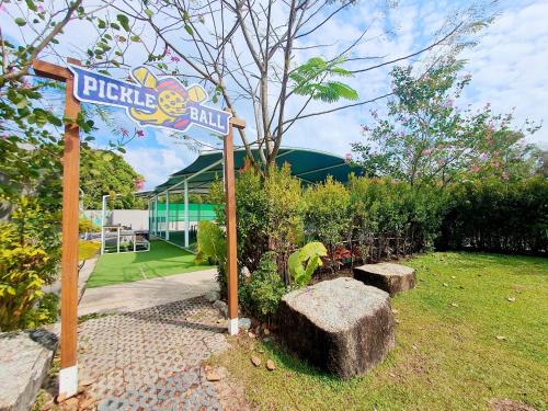 a sign for a pizza shop in a garden at Anantara Vacation Club Mai Khao Phuket in Mai Khao Beach