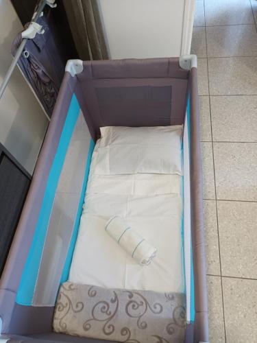 a toy bed with a mattress in a room at LOCATIONS VERT EDEN in La Plaine des Cafres