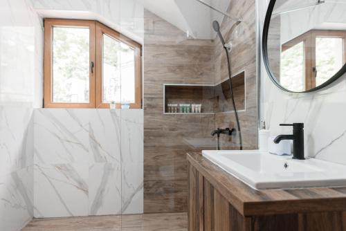 a bathroom with a sink and a mirror at Lux House with own parking in Skopje in Skopje