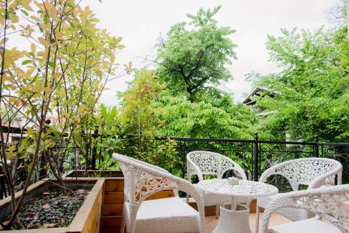 a patio with white chairs and a table at Lux House with own parking in Skopje in Skopje