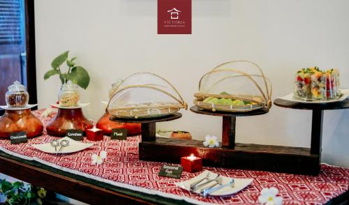 a table with three tiers of food on a table at Victoria XiengThong Palace in Luang Prabang