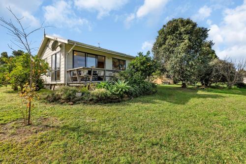 a home with a large yard with a house at Enchanted Retreat - Kerikeri Holiday Home in Kerikeri