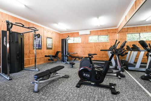 a gym with several exercise bikes and treadmills at Powerhouse Hotel Tamworth by Rydges in Tamworth