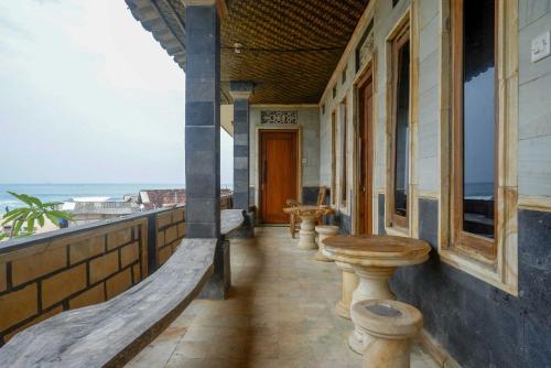 a porch of a building with a view of the ocean at Hotel Kampoeng Drini RedPartner in Brono