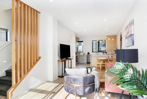 a living room with a couch and a tv at Your home away from home located near Auckland CBD in Auckland