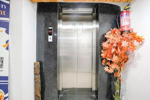 a elevator in a building with a vase of flowers at FabHotel Vrundavan, Athwa in Bhatha