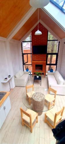 a living room with a couch and chairs and a fireplace at Bosquecielo in Huasca de Ocampo